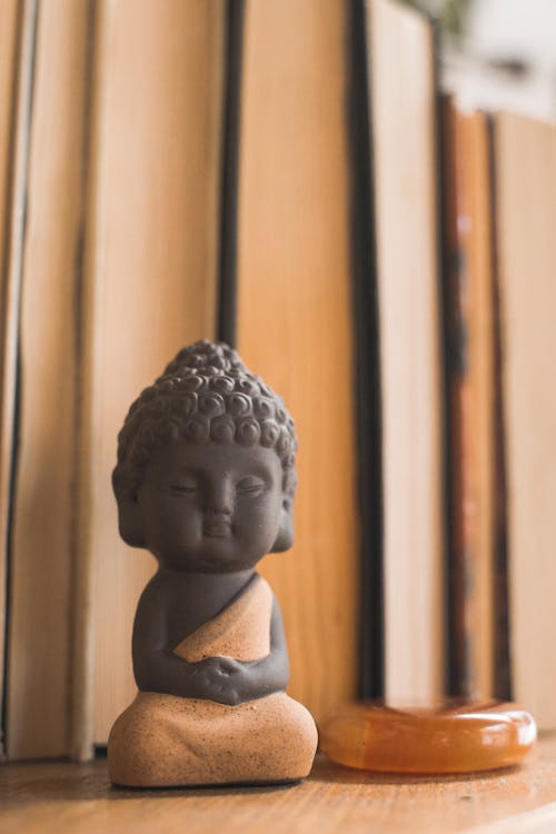 Close-Up Photo of a Miniature Buddha Figurine