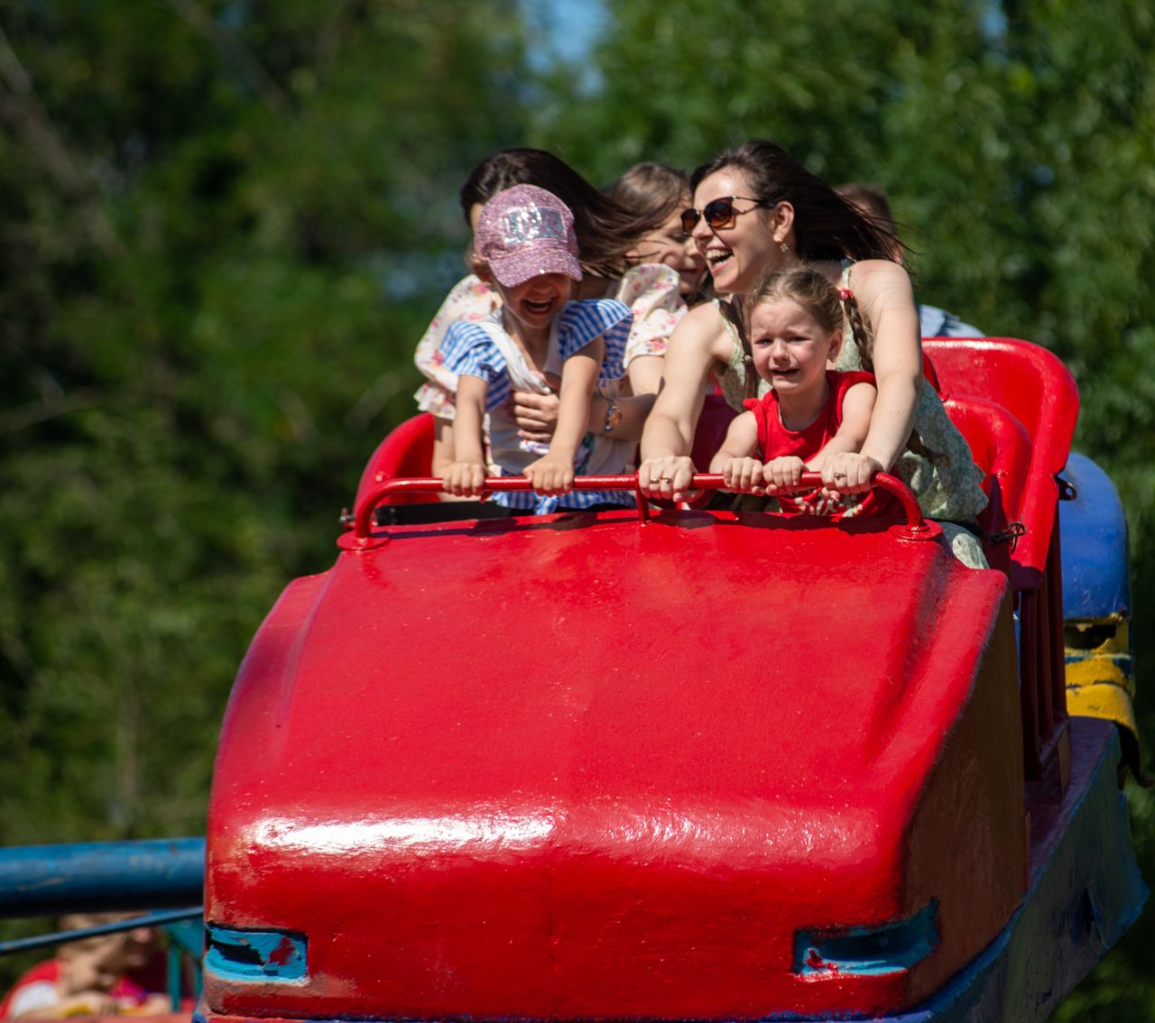 a group of children and adults experience thrill and joy on a roller c