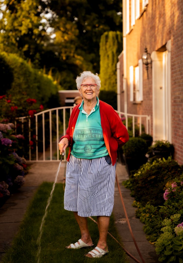 Senior Woman Watering Garden