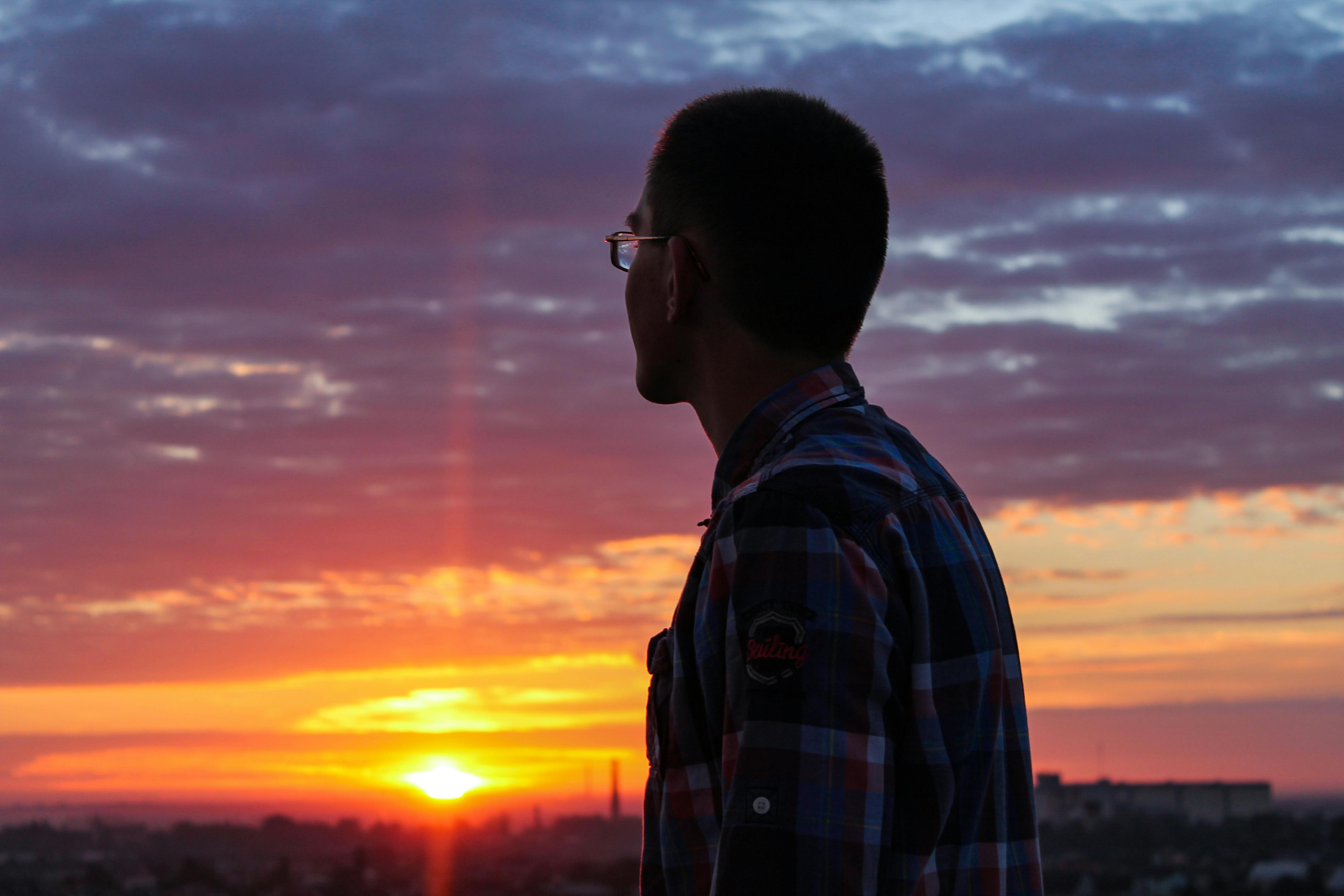 Free stock photo of A guy looking at sun rising up
