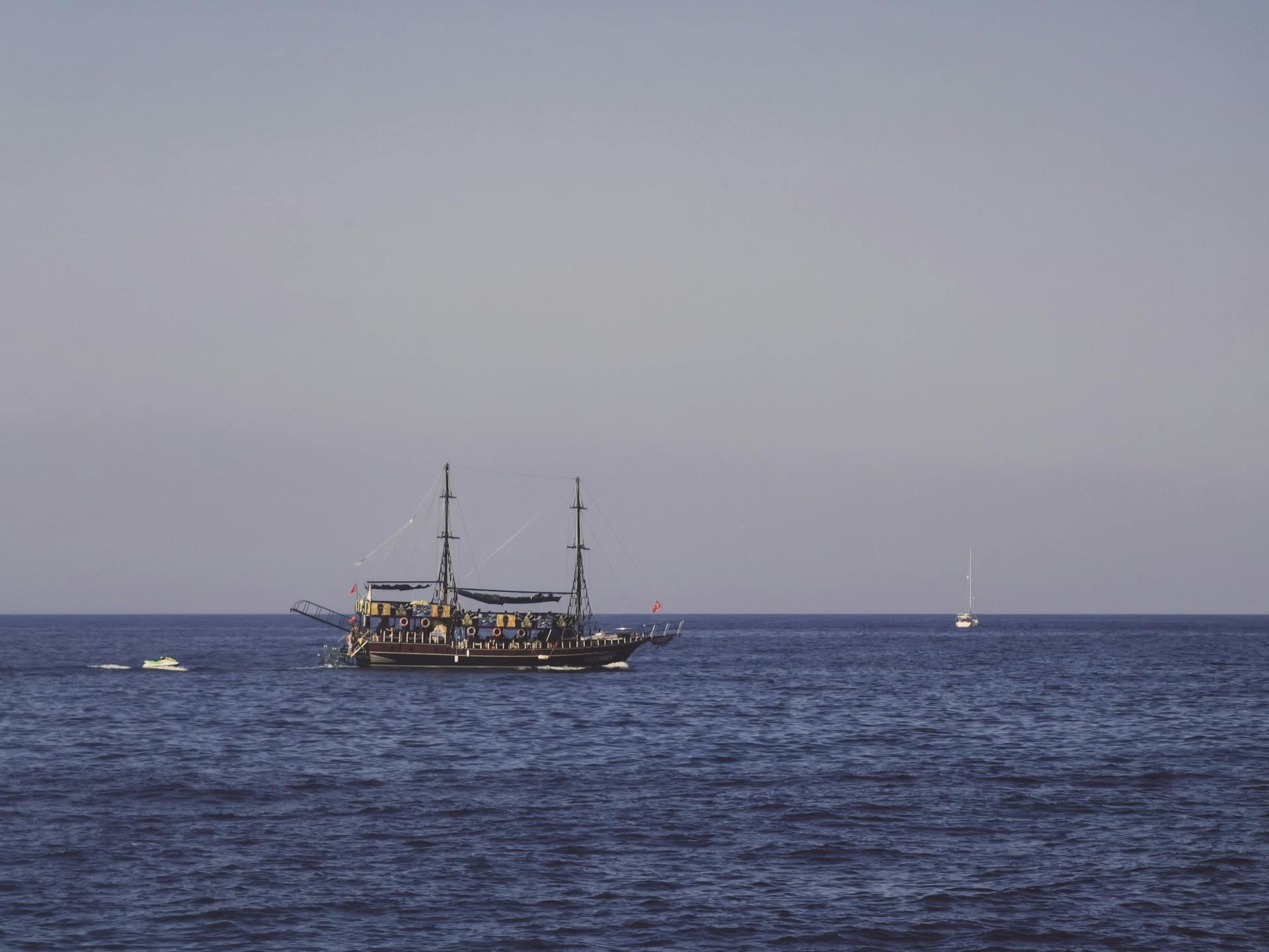 Vintage ship elegantly sailing on the serene Mediterranean Sea near Kyrenia, under a clear blue sky.