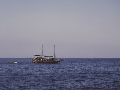 Free Vintage ship elegantly sailing on the serene Mediterranean Sea near Kyrenia, under a clear blue sky. Stock Photo