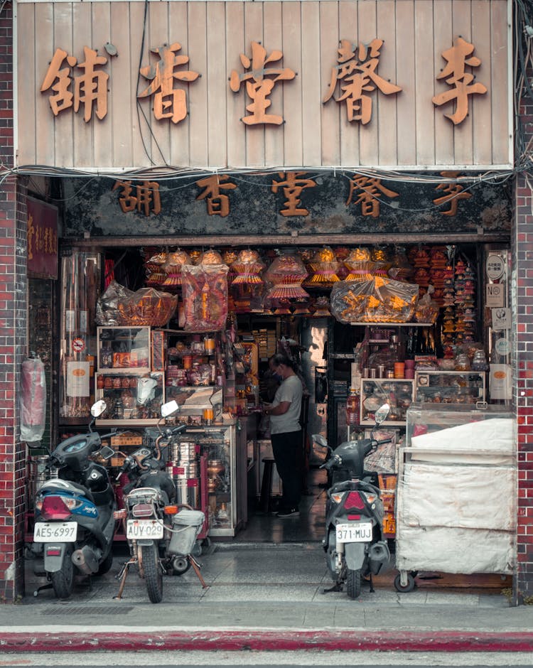 Motorcycles Parked In Front Of A Store