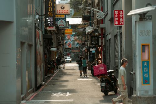 Free Explore a vibrant urban alleyway in Asia, adorned with colorful signages and bustling activity. Stock Photo