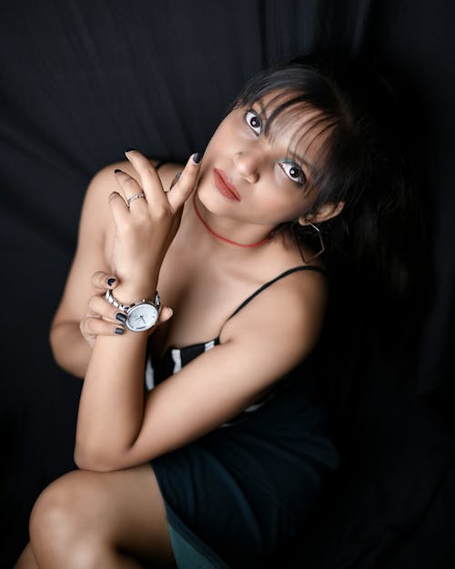 Close-Up Shot of a Woman in Black Sleeveless Dress