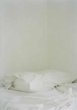 Cozy and minimalist white bedding in an apartment in Seoul, conveying comfort and simplicity.