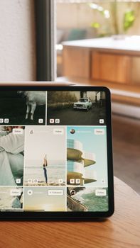 A tablet showcasing social media photos in a cozy Istanbul café setting, highlighting technology use.
