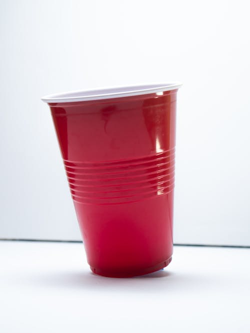 Close-Up Shot of a Red Plastic Cup on White Surface