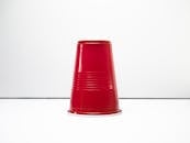 Close-Up Shot of a Red Plastic Cup on White Surface