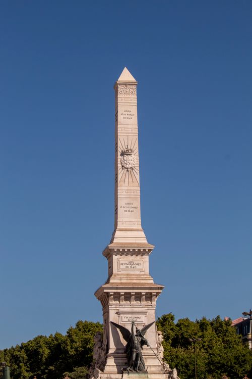 Free Majestic obelisk monument set against a clear blue sky, standing tall outdoors. Stock Photo