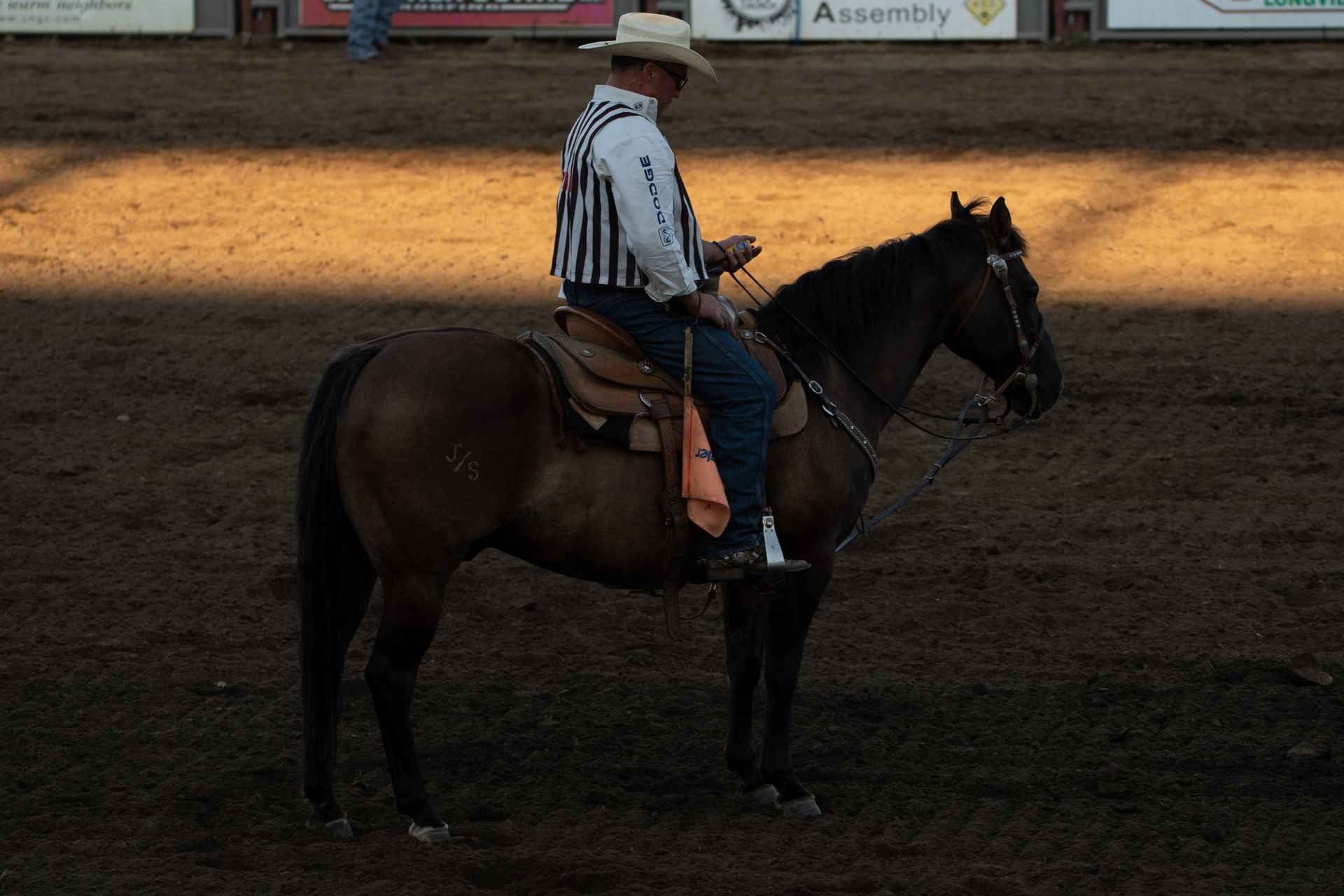 A cowboy horseback riding in Longview, WA arena during a rodeo. Western style and culture.