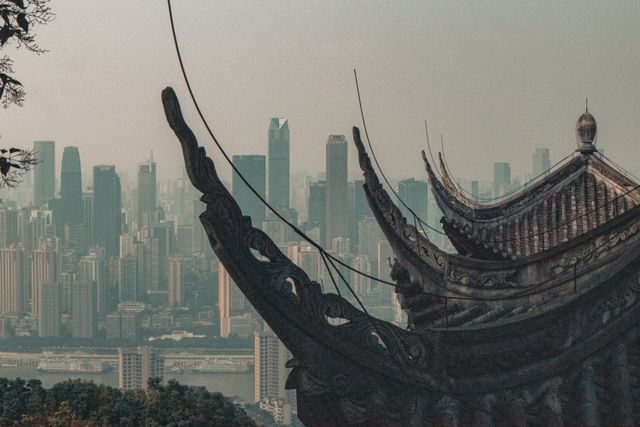 A traditional temple roof contrasts a modern skyline, showcasing architectural diversity.