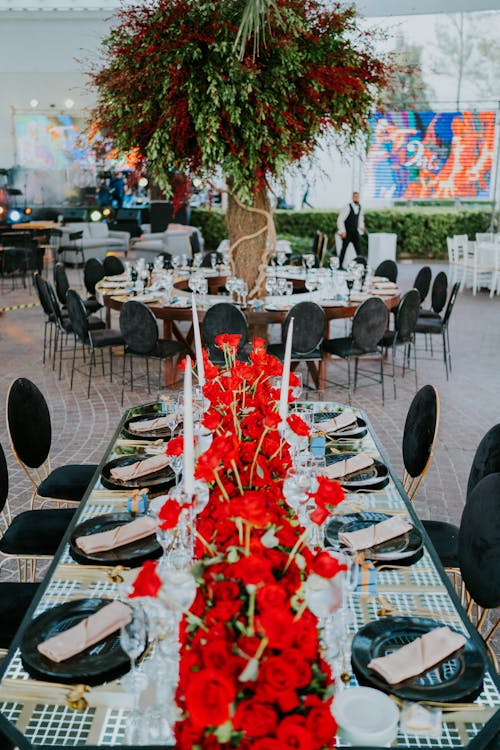 A Table Set up with Red Flower Arrangement 