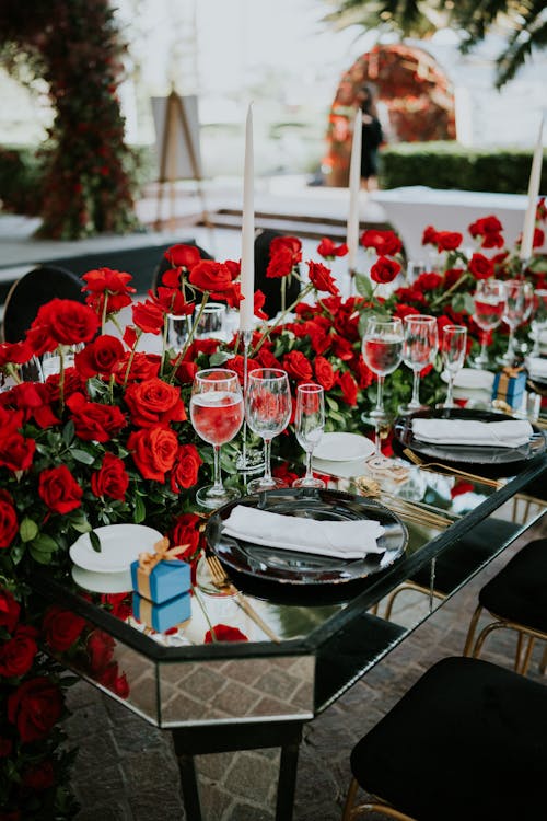 Red Roses on Table With Plates and Bowls