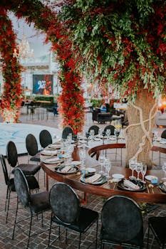 Beautiful round dining setup outdoors with vibrant floral decorations, ideal for urban dining experiences.