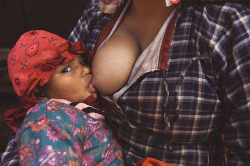 A Person Breastfeeding a Child 