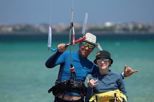 Man Holding Red and White Fishing Rod