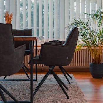 A stylishly designed conference room with modern chairs and potted plants.