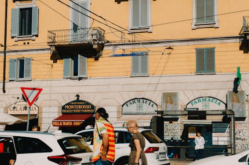 People, Cars and Buildings by a City Street