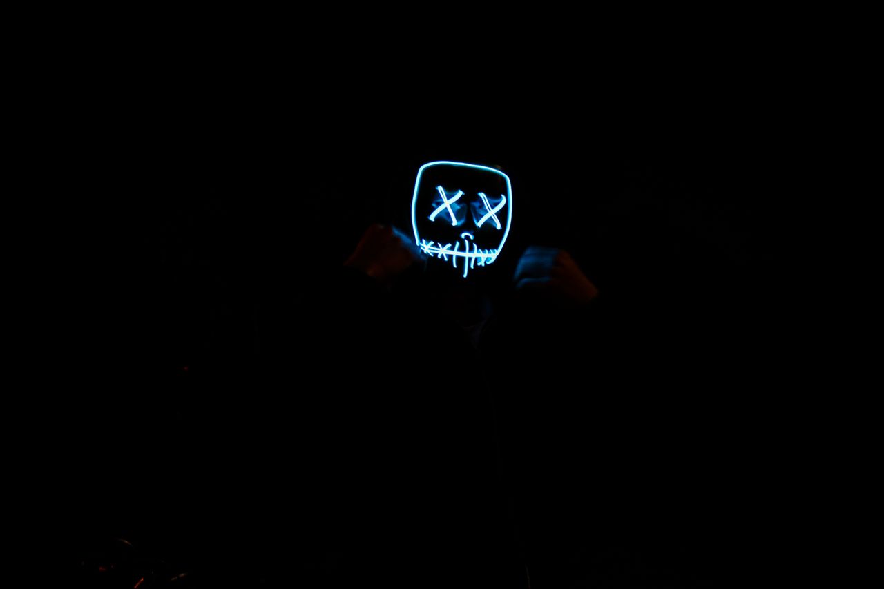 a glowing led mask in a dark environment creates a mysterious and eeri