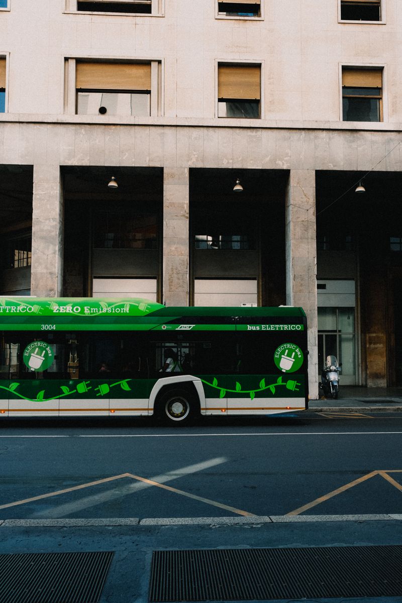 Green electric bus on city street promoting zero emissions