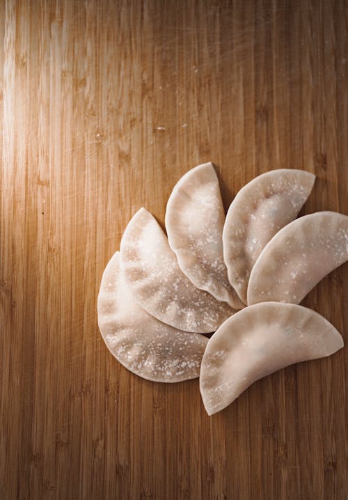 Uncooked Dumplings on a Wooden Surface 