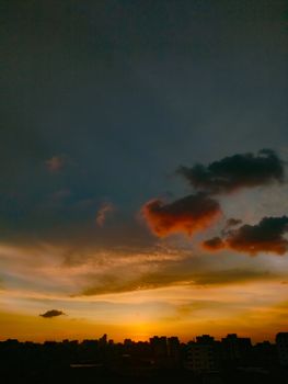 Captivating shot of the sunset casting vibrant hues over the city skyline in Bangladesh.