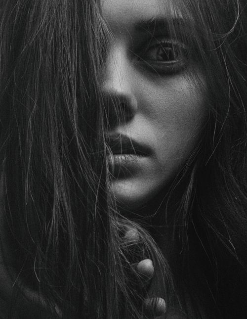 Free Close-up black and white portrait of a woman with intense expression and dramatic lighting. Stock Photo