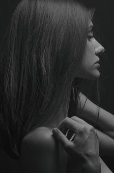Artistic side-profile portrait of a woman in monochrome capturing depth and emotion.