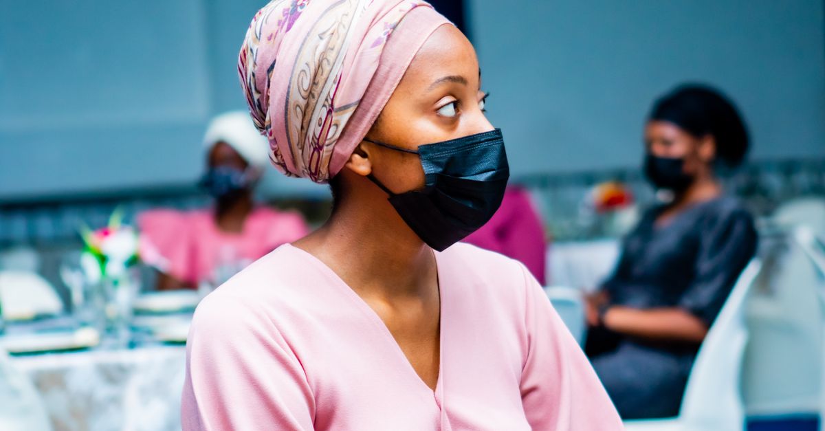 A vibrant evening fellowship gathering in Ho, Ghana with people smiling and connecting