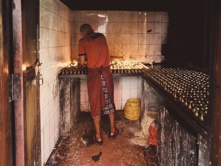 A Man Lighting Candles