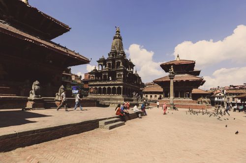 Free Vibrant scene at Patan Durbar Square, Nepal, showcasing ancient temples and tourists. Stock Photo