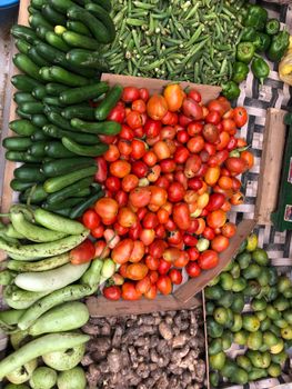 A vibrant assortment of fresh vegetables displayed at an outdoor market stall, showcasing healthy living.
