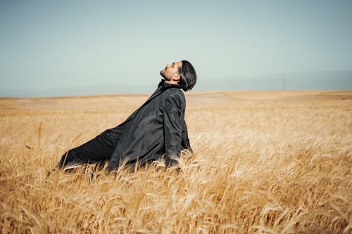 Man in the Middle of a Grass Field
