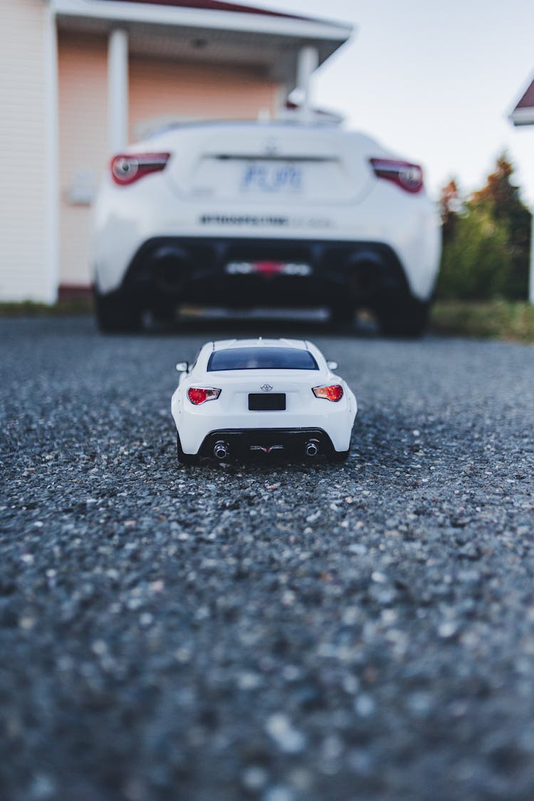 Toy Car And Vehicle Near House