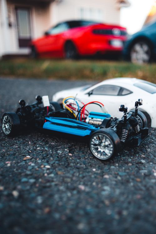 Free Detailed view of remote-control cars on asphalt with blurred background Stock Photo
