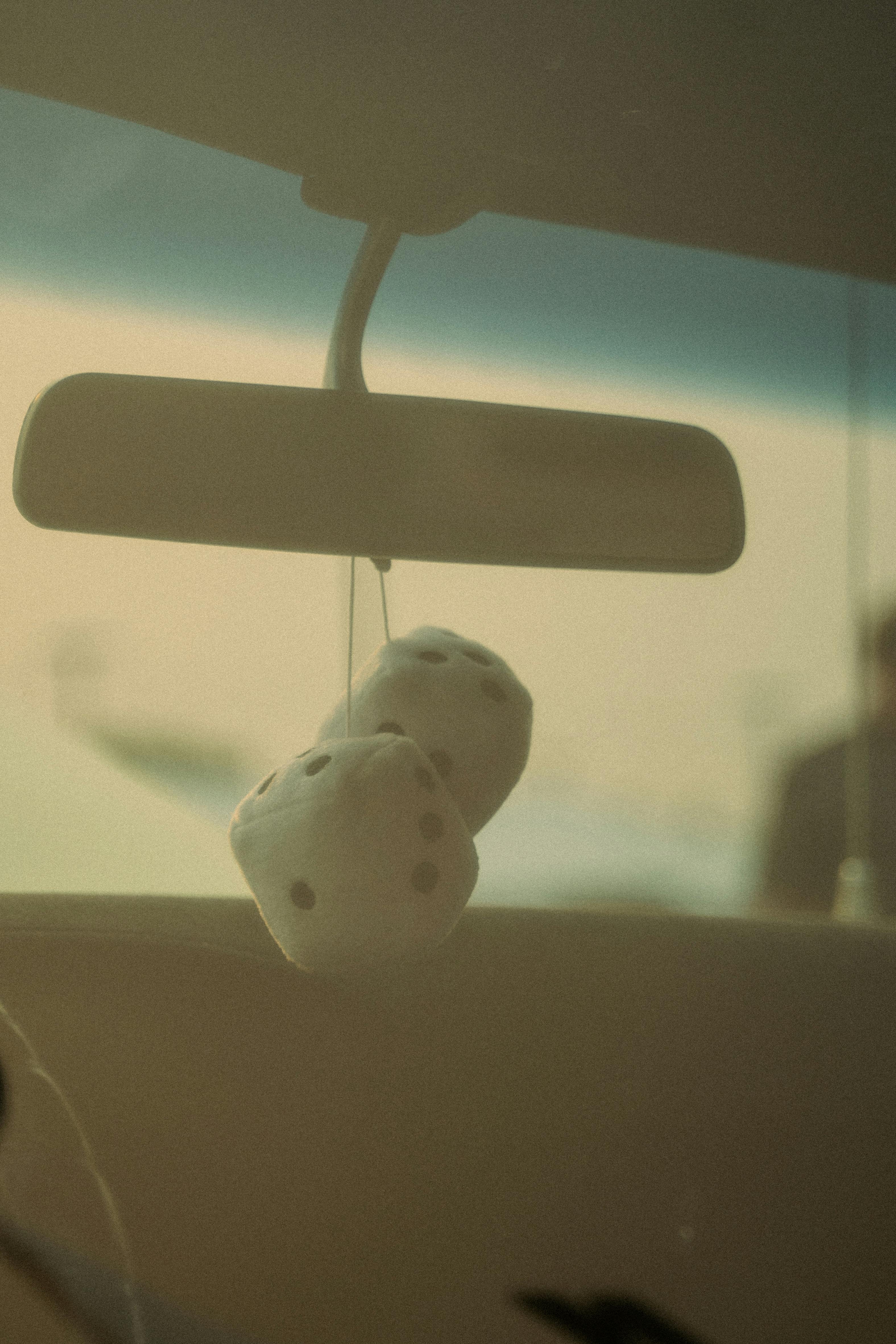 Plush Dice Hanging on Rearview Mirror · Free Stock Photo