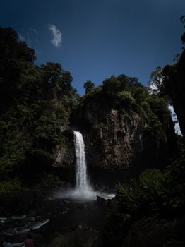 Breathtaking waterfall surrounded by lush greenery in Xico, Veracruz, Mexico, captured on a sunny day.