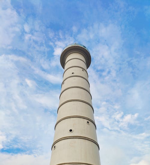 Low Angle Shot of a White Concrete Tower Under the Blue Sky