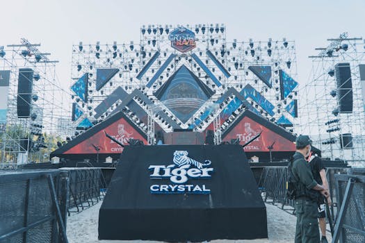Outdoor stage setup for a major event featuring Tiger Crystal branding and structural lighting.