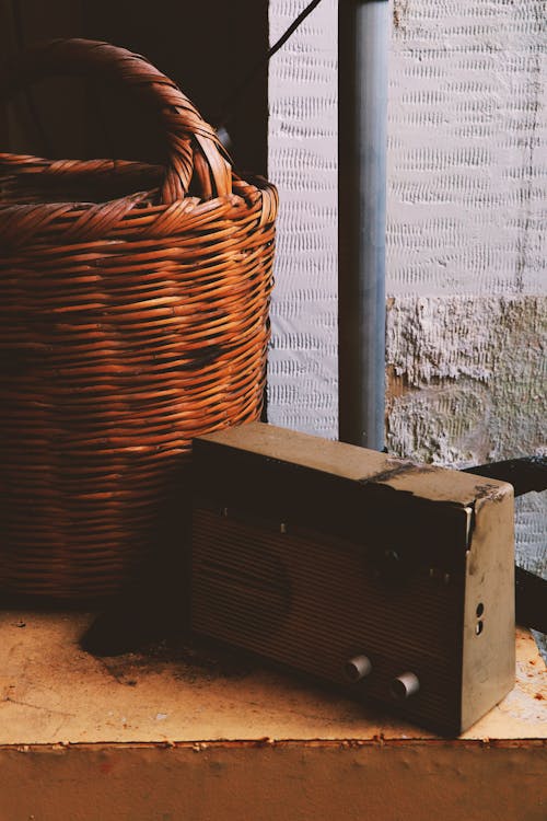 Brown Wicker Basket Near an Old Radio 