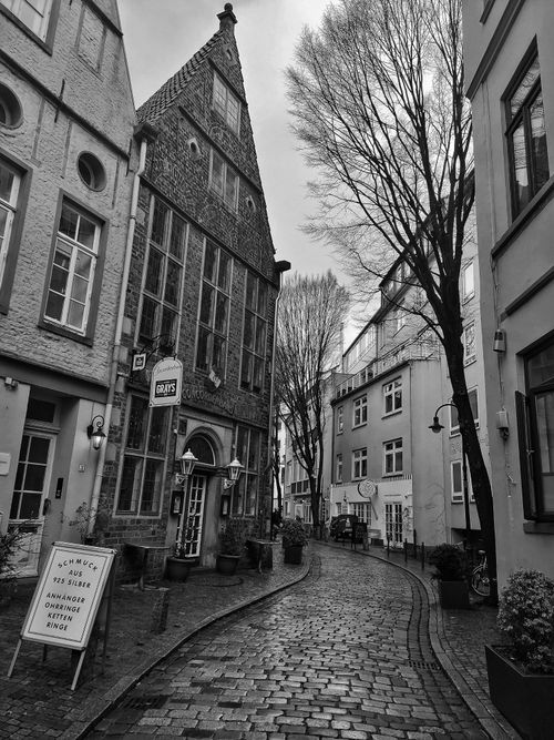 Free Explore a quaint cobblestone alley with historic buildings in a European cityscape. Stock Photo