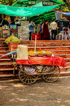 Vibrant street market with a traditional wooden cart in the foreground.