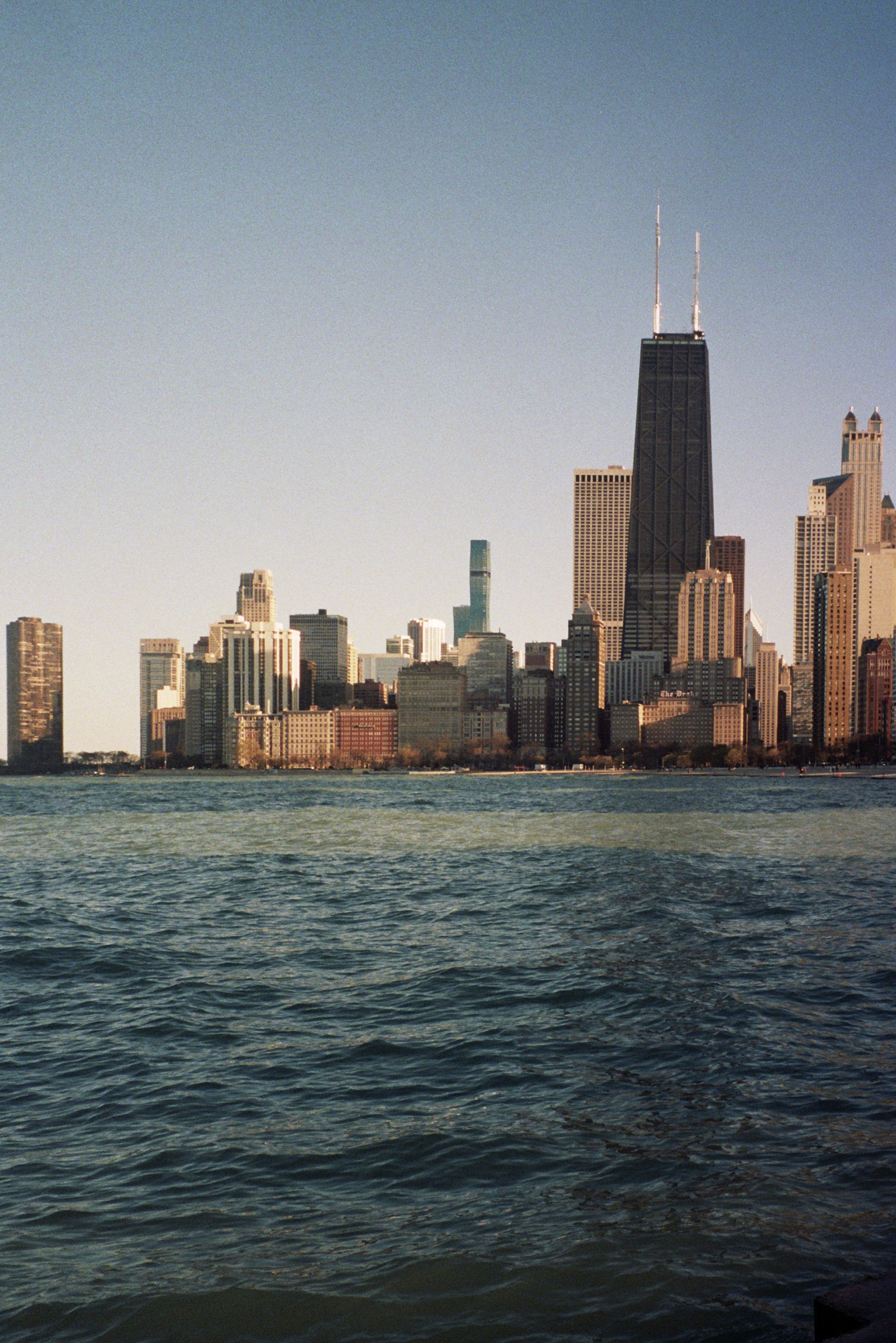 A City with Tall Buildings Near a Body of Water Under Blue Sky · Free ...