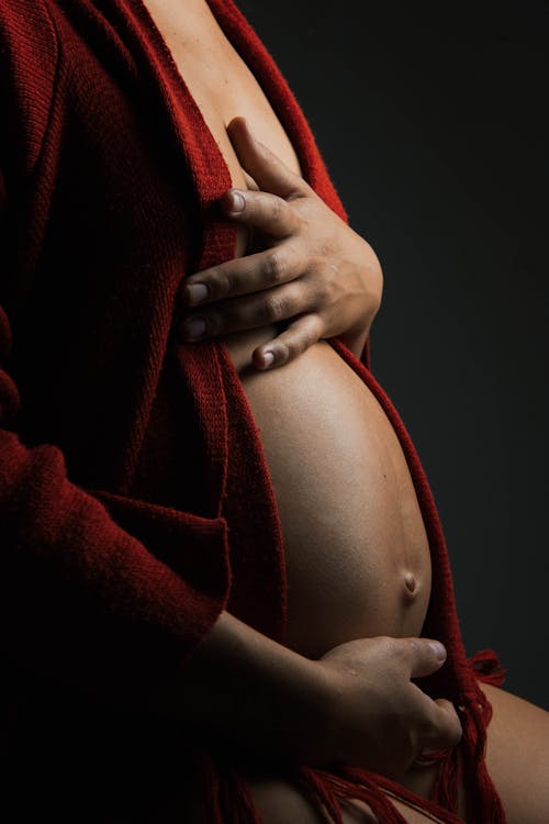 Free A Pregnant Woman in Red Bath Robe  Stock Photo