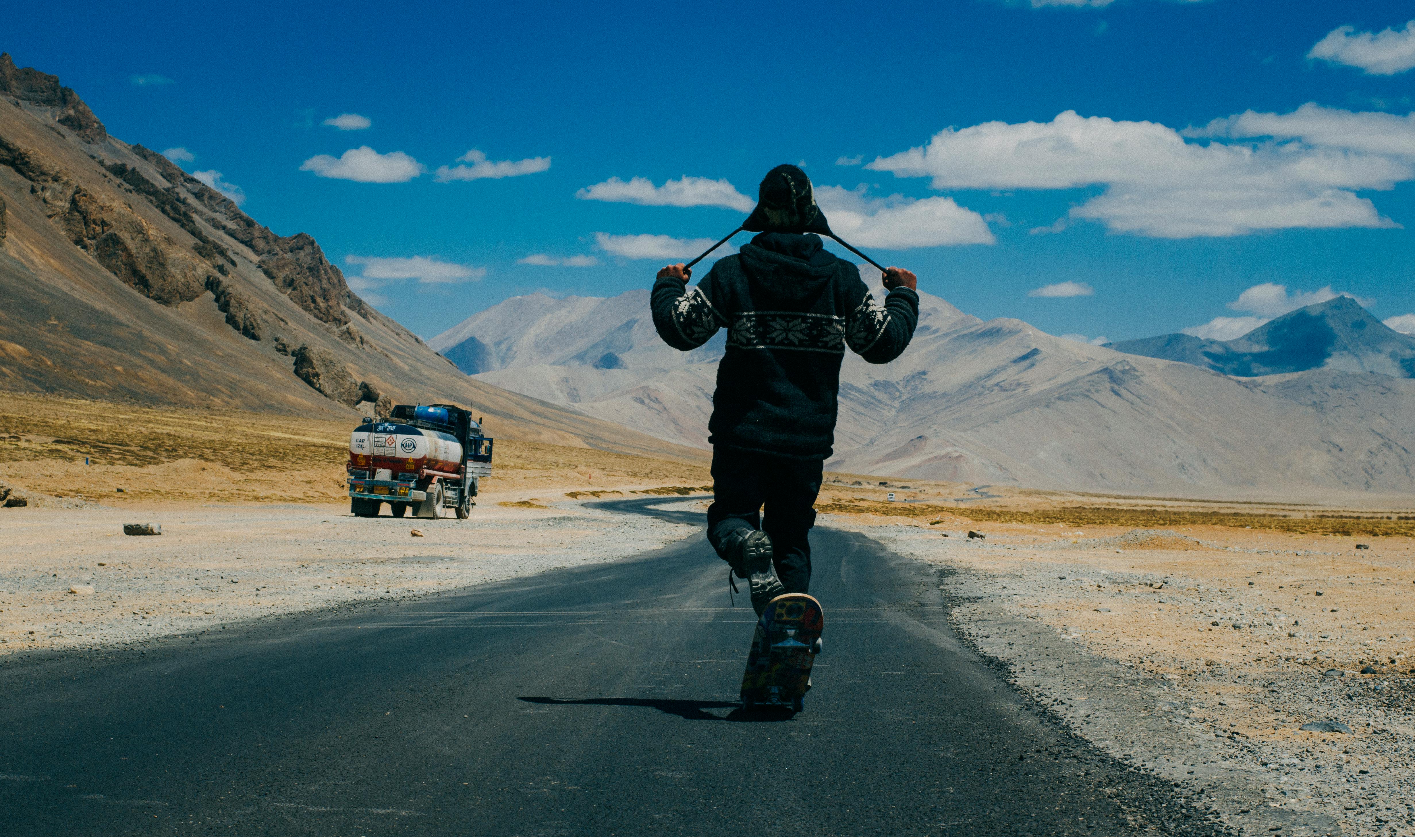 Ladakh Photo by Abhishek Gaurav from Pexels: https://www.pexels.com/photo/person-walking-while-holding-his-hat-strap-1305603/