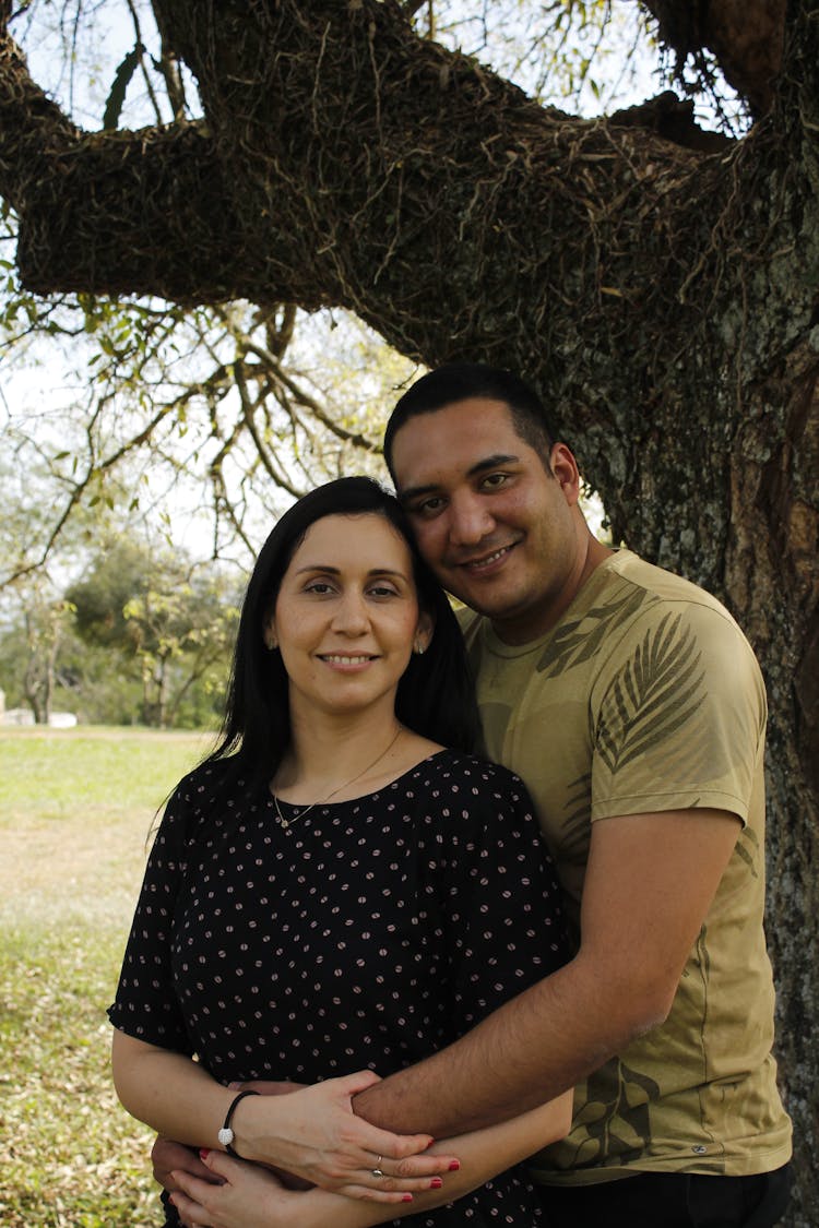 A Man Hugging A Woman From Behind 