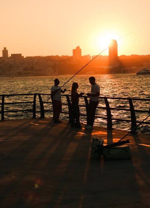 People Fishing during Sunset