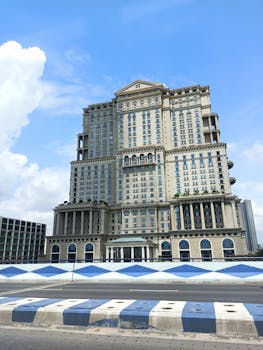 Elegant facade of the ITC Royal Bengal hotel against a vibrant blue sky in Kolkata.