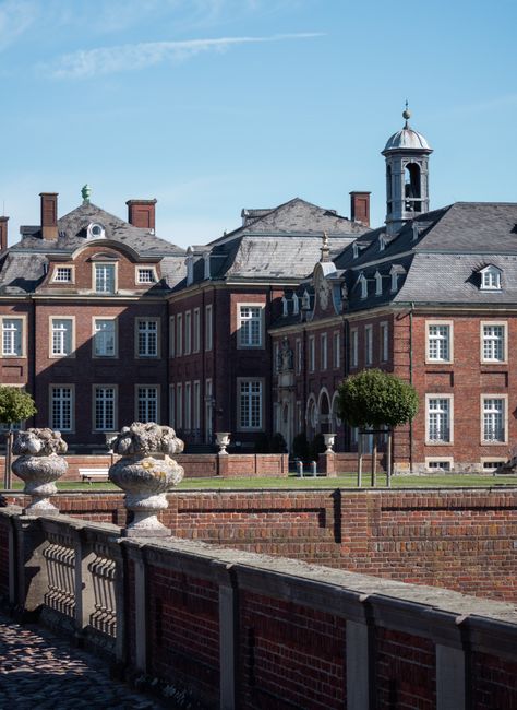 Stately baroque castle with grand architectural design, captured on a sunny day.